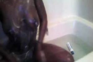 Extremely hot and charming ebon hottie dildoing herself in the bath