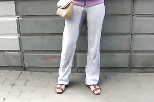 Irina pees her pants and changes her garments in a park