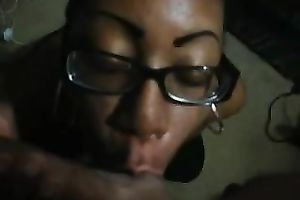 Black hussy in glasses kneels in front of me to engulf my ramrod