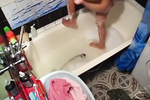 Tanned playgirl with diminutive milk shakes is masturbating in the bathtub
