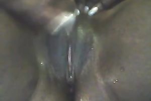 Dirty and concupiscent dark girlfriend playing with her vagina in closeup movie scene