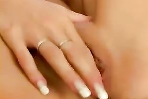 Sensual and cute youthful beauty on the armchair playing with herself