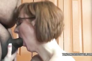 Slender nerdy redhead whore is going down on a unbending dick