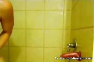 Horn-mad auburn girlie is fond of dildoing her own holes in the shower