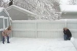 Wicked wife positions for the camera during a snowfall in backyard