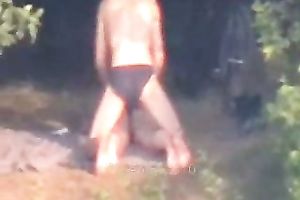 Peeking on one non-professional pair having enjoyment on the lake shore