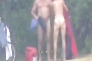 Peeking on one non-professional pair having enjoyment on the lake shore