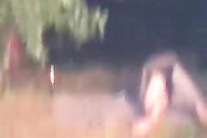 Peeking on one non-professional pair having enjoyment on the lake shore