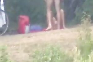 Peeking on one non-professional pair having enjoyment on the lake shore