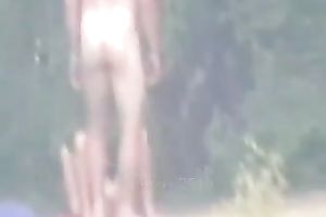 Peeking on one non-professional pair having enjoyment on the lake shore