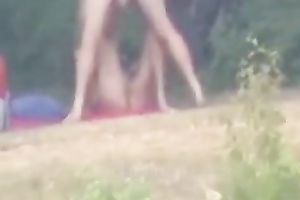 Peeking on one non-professional pair having enjoyment on the lake shore