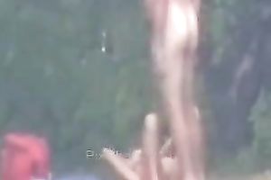 Peeking on one non-professional pair having enjoyment on the lake shore