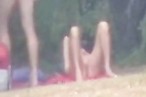 Peeking on one non-professional pair having enjoyment on the lake shore