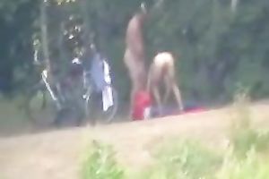 Peeking on one non-professional pair having enjoyment on the lake shore