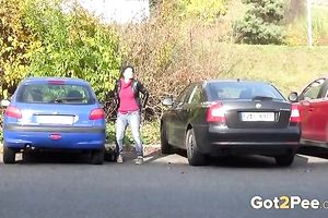 Nice shaped dilettante dark brown is just pissing on the parking lot