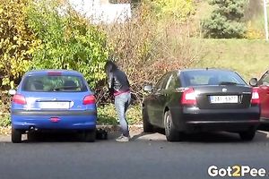 Nice shaped dilettante dark brown is just pissing on the parking lot