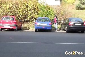 Nice shaped dilettante dark brown is just pissing on the parking lot