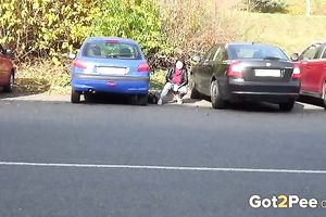 Nice shaped dilettante dark brown is just pissing on the parking lot