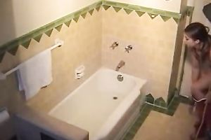 Sweet looking brunette playing with her slit in a bathtub