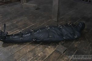 This leather sleep sack is very taut on slave's body