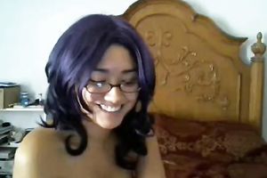 Cute black purple haired cutie in glasses positions topless on livecam