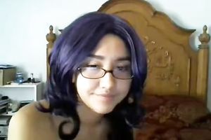 Cute black purple haired cutie in glasses positions topless on livecam