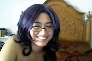 Cute black purple haired cutie in glasses positions topless on livecam