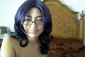 Cute black purple haired cutie in glasses positions topless on livecam