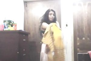 Cute lengthy haired Indian gal shows off in her bright saris