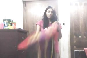 Cute lengthy haired Indian gal shows off in her bright saris