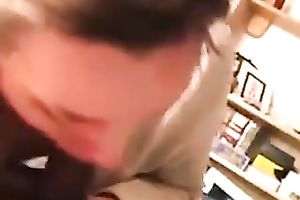 Curly secretary of my buddy works on his large chubby prick with pleasure