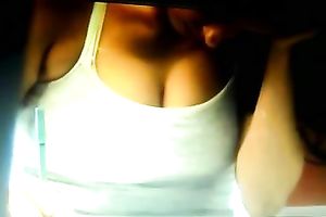 A breasty brunette playgirl on the reception desk has her bra buddies falling out of her top