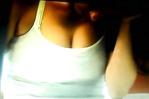 A breasty brunette playgirl on the reception desk has her bra buddies falling out of her top