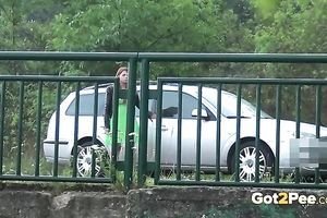 Kinky brunette chick has no thing against to pee right on the bridge