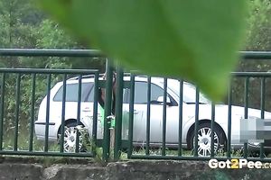 Kinky brunette chick has no thing against to pee right on the bridge