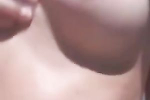 Dainty amateur wife oils up her taut body on the lonely beach