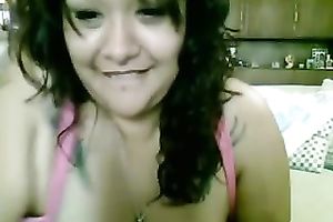 Tattooed bosomy brunette hair smiles during the time that masturbating