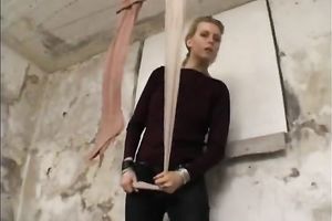 Sassy golden-haired female stiffs and puts on nylon hose