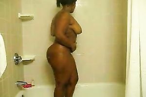 Awesome large bottomed chocolate nympho takes a shower and masturbates