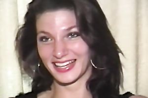 Mesmerizing and cute dark brown chick on the bed in front of livecam