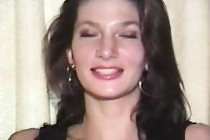 Mesmerizing and cute dark brown chick on the bed in front of livecam