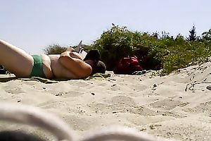 Topless woman with massive bazookas caught sunbathing on a naked beach