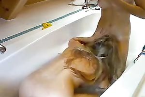 Blonde and brunette hair best allies cuddle in the bathtub