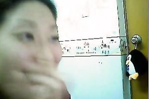 Pretty wonderful natural Asian brunette gets busy with fingering her pleasant snatch