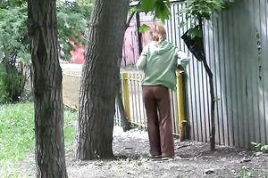 Cute and small Russian playgirl changes raiment outside
