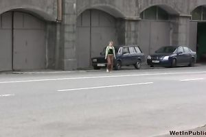 Cute and small Russian playgirl changes raiment outside