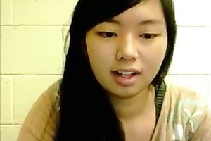 Asian juvenile cutie rubs her snatch and teats on cam