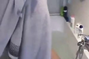 Beautiful non-professional dark brown is washing her large titties in a baths tub