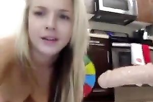 My glamorous golden-haired girlfriend engulfing big sex toy in front of camera