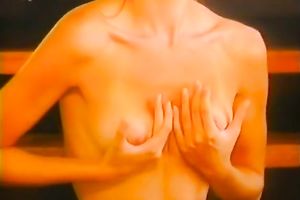 Marvelous redhead seductress of the 90's disrobes and bows over on the ottoman